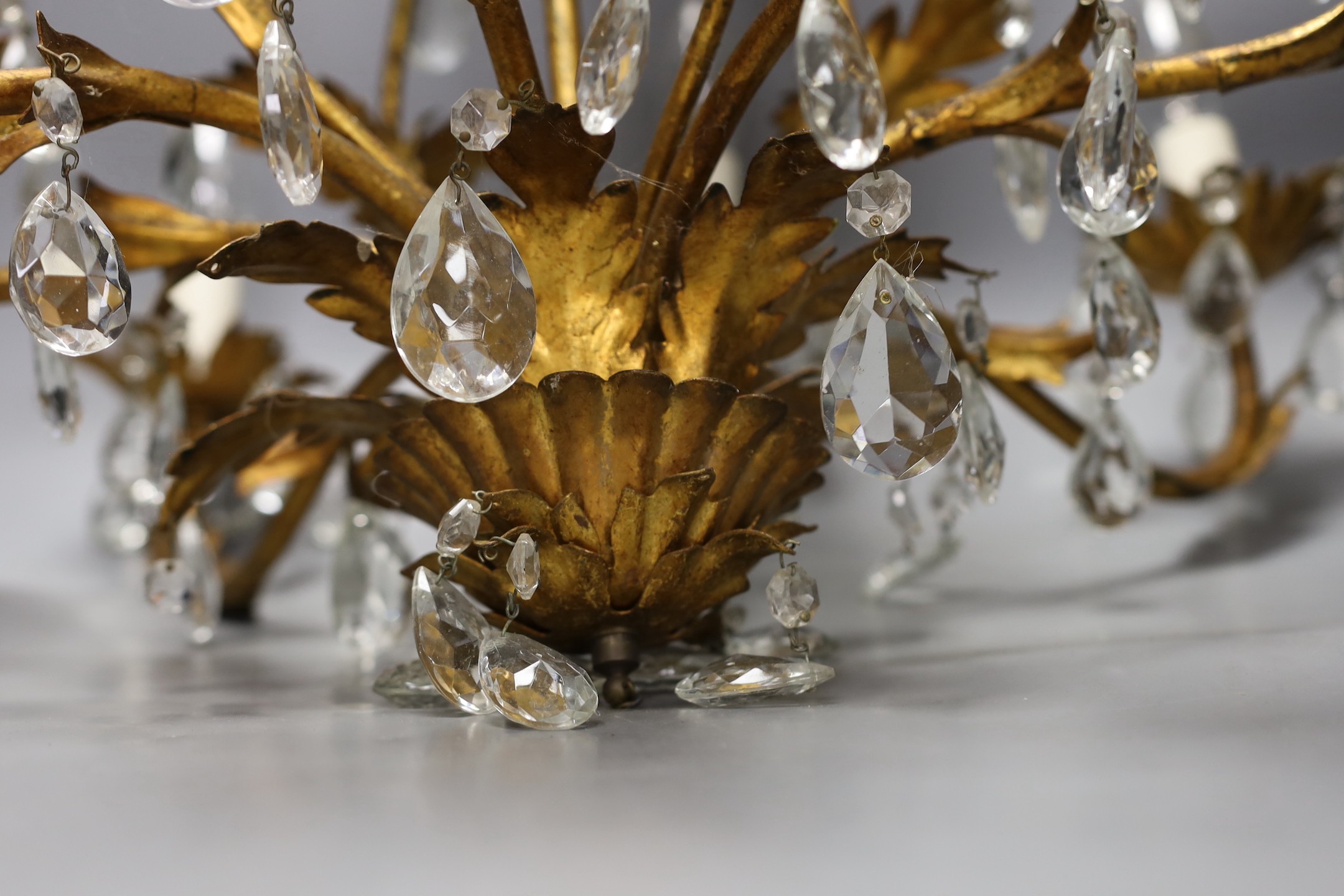 A French gilt metal and cut glass drop eight branch, electrolier, 58 cms high.